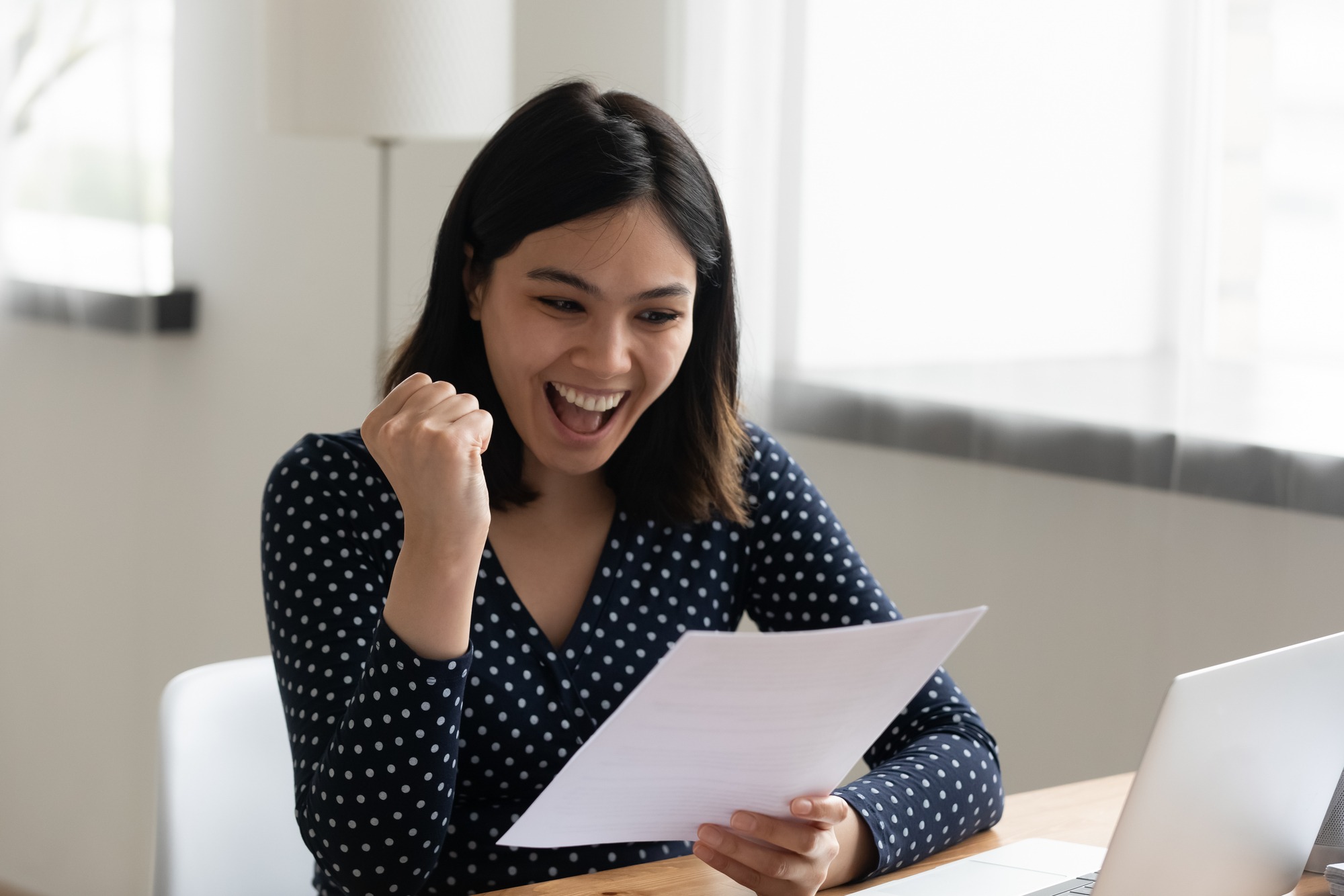 Amazed young mixed race female student hold official written letter